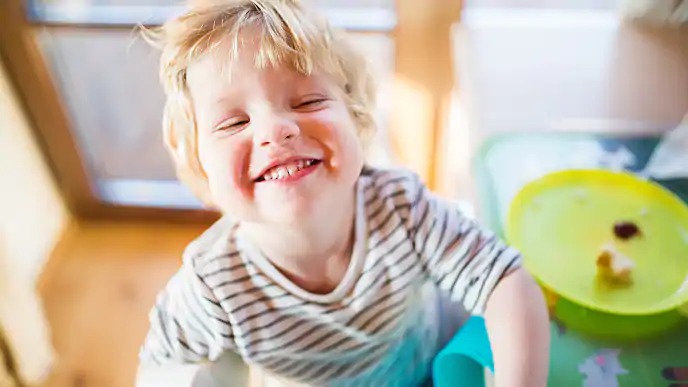 toddler with buck teeth smiling