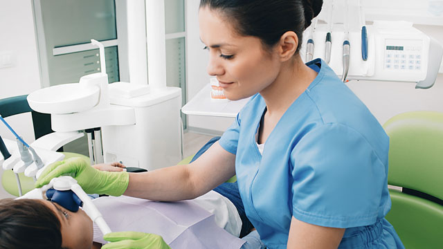 Healthcare professional administering laughing gas.