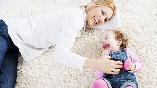 Mãe e filha brincando no chão