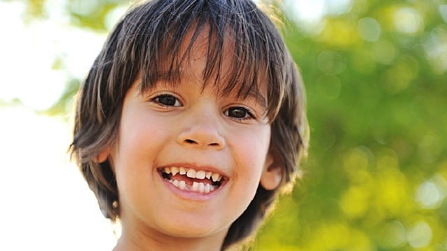 menino com dentes decíduos