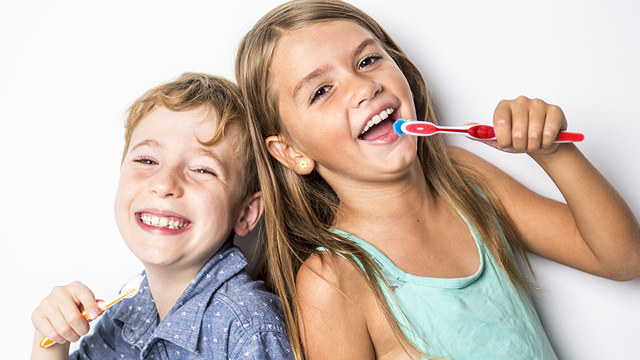 brother and sister washing thier teeth